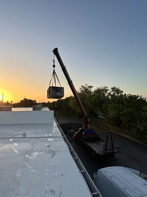 Crane set at sunrise — Packaged rooftop unit rigged, lifted, and running the same day (Wonder Air & Heat, Brevard County FL)