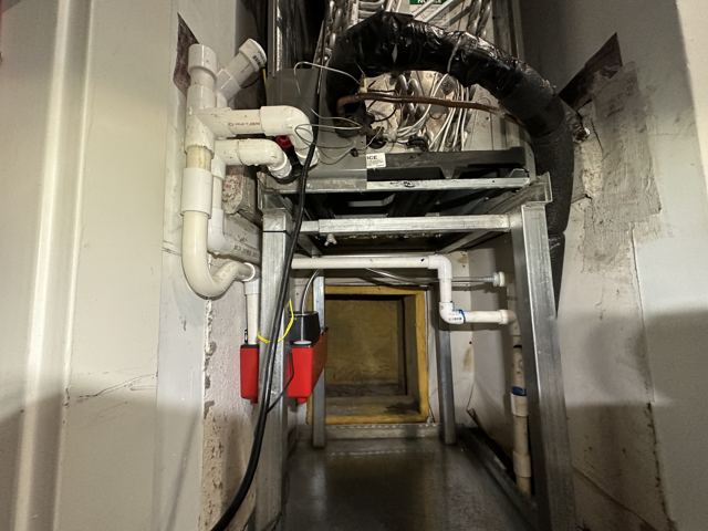 Coil & condensate work — Elevated stand, condensate pump, and fresh PVC drain runs in a tight space (Wonder Air & Heat, Brevard County FL)