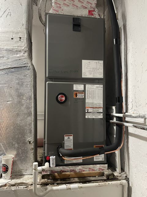 Finished closet install — Second angle: insulated lines, safe-t drain, and clean cabinet fit (Wonder Air & Heat, Brevard County FL)