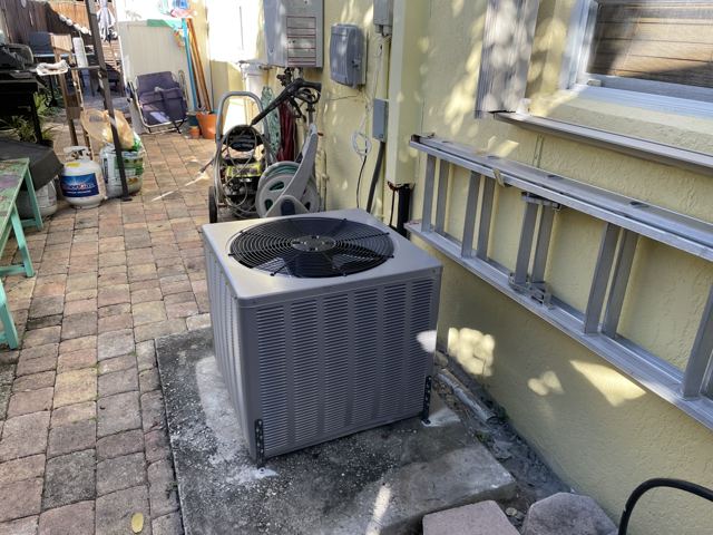 New condenser install — High-efficiency condenser set level on a fresh pad with new whip, disconnect, and tie-downs (Wonder Air & Heat, Brevard County FL)