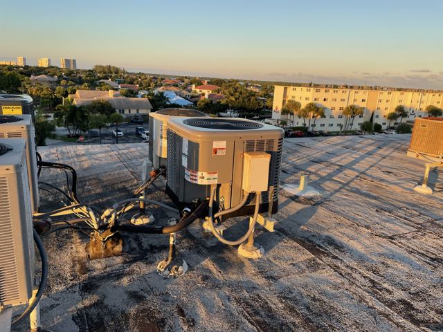 Rooftop condensers — coastal Brevard — Multi-unit rooftop replacement serving a waterfront condo building, with elevated stands and sealed penetrations (Wonder Air & Heat, Brevard County FL)