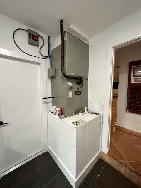 Variable-speed closet install — Clean hallway-closet installation with new disconnect, lineset, and condensate drain (Wonder Air & Heat, Brevard County FL)