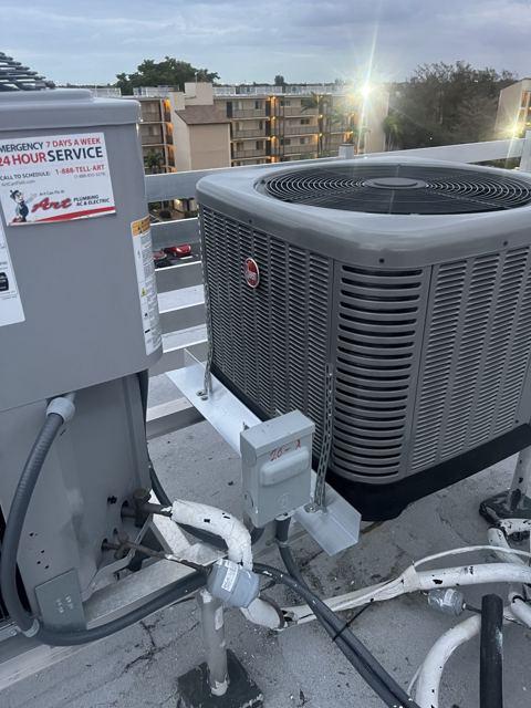 Condo rooftop condenser swap — New Rheem condenser replacing failed equipment on a mid-rise rooftop (Wonder Air & Heat, Brevard County FL)