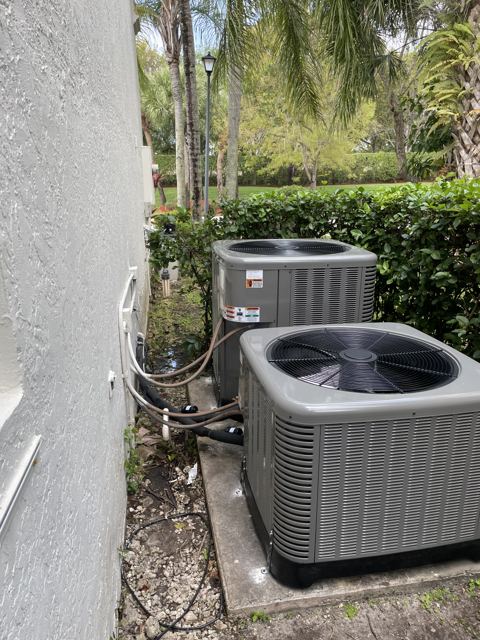Dual-system home — Matched pair of Rheem condensers serving a two-zone home (Wonder Air & Heat, Brevard County FL)
