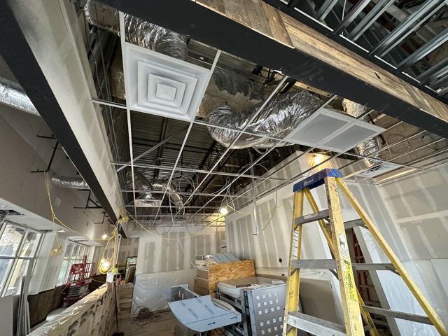 Diffusers & grid rough-in — Ceiling diffusers and insulated flex set during a commercial renovation (Wonder Air & Heat, Brevard County FL)