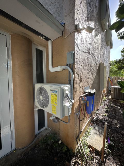 Ductless mini-split install — Wall-mounted mini-split condenser with clean line-hide down the wall (Wonder Air & Heat, Brevard County FL)
