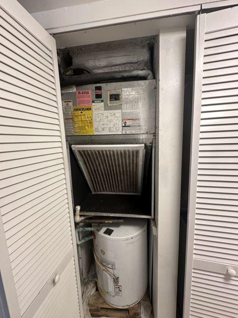 Before: tired closet system — What we found — rusted cabinet and starved airflow (Wonder Air & Heat, Brevard County FL)