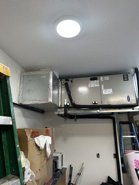 Ceiling-hung garage unit — Horizontal air handler suspended to free up garage floor space (Wonder Air & Heat, Brevard County FL)