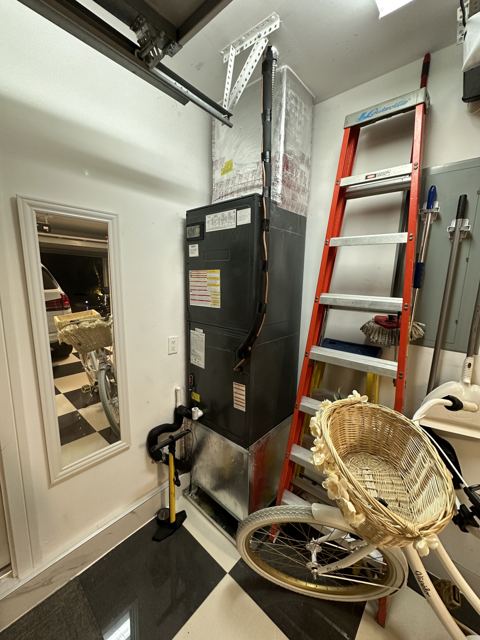 Garage utility-corner system — Tall vertical configuration tucked cleanly into the garage corner (Wonder Air & Heat, Brevard County FL)